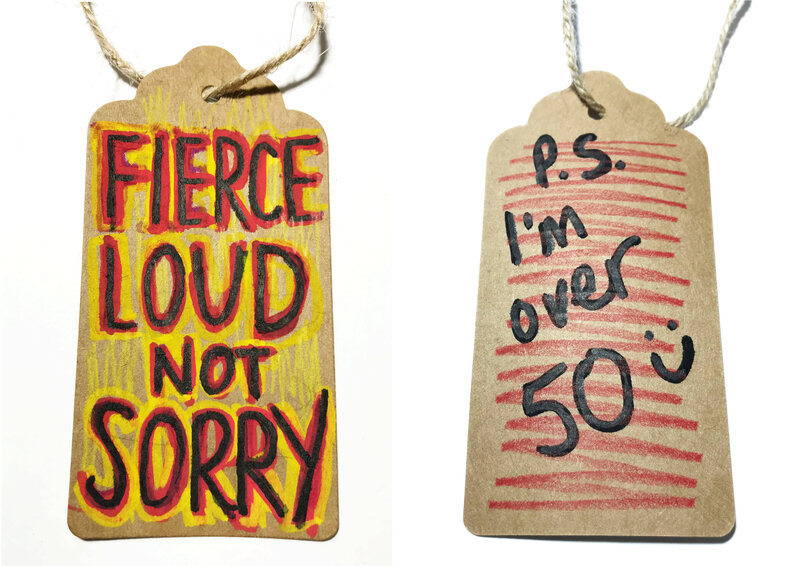 Two sides of the same label - Bold red, yellow and black lettering says Fierce, loud, not sorry. and on the other side it says, PS I'm over fifty with a smiley face drawn. Caroline Cardus