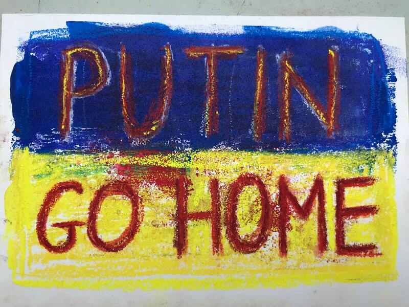 An ink print in Ukrainian flag colours with the words 'Putin Go Home' in red. Caroline Cardus. 