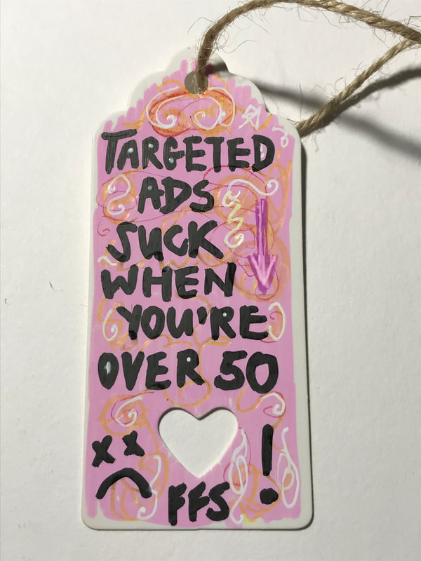An ornately decorated label which says 'targeted ads suck when you're over 50' Caroline Cardus
