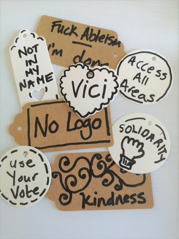 A group of 8 labels - not in my name, Vici, access all areas, no logo, use your vote, solidarity, Kindness. Vici Wreford-Sinnott