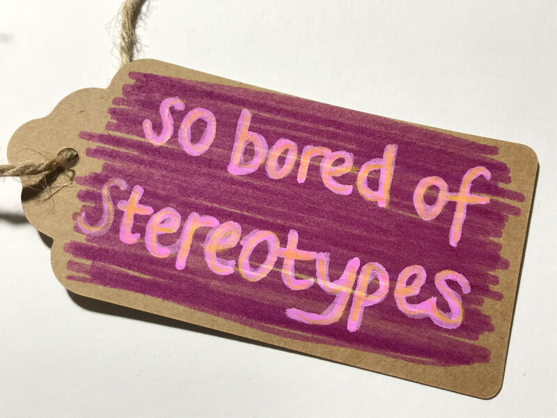 Brown parcel label coloured in dark and light pink which  says 'so bored of stereotypes' Caroline Cardus
