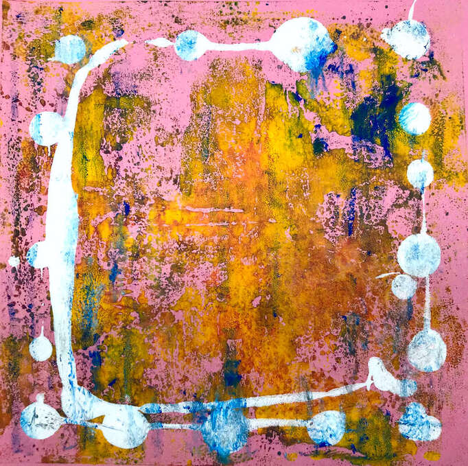 A pink background. Printmaking involves rolling several layers of coloured inks to create abstract images. The artist has selected yellow as a dominant colour, overlaid with small patches of dark blue. A bold white ink has been trailed around the image with bold white drops of ink, creating a very effective 'square' circle. 