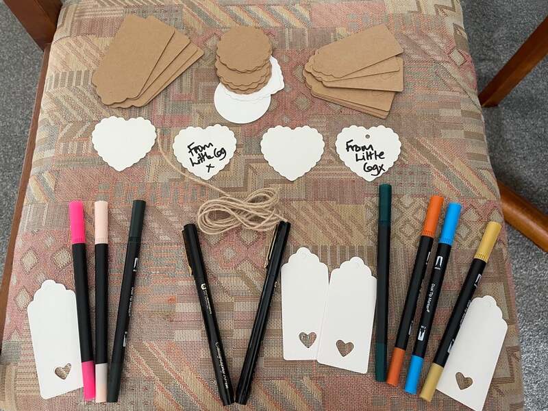 Neatly arranged balnk labels, string and artist's brush pens. Two love hearts say From Little Cog x  Samantha Blackburn