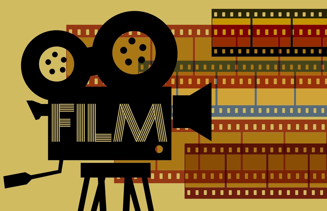 On a beige background the is an illustration of a black old fashioned movie camera and reel, with the word film on it. In the background on the right-hand side there are 5 strips of movie celluloid.