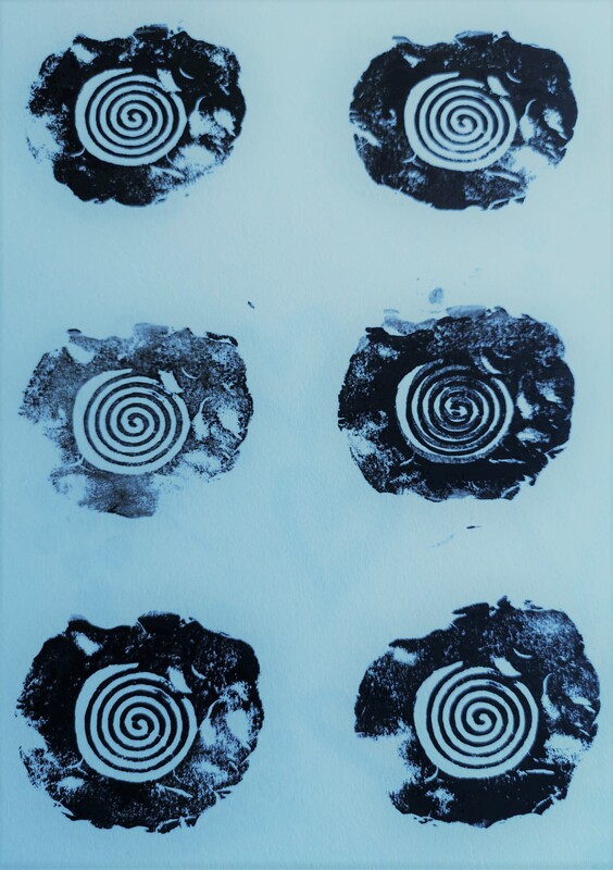 Again, black ink with a digitally added blue background. Six repeat images of the earlier single ammonite shape, with each ione being individual and unique. One is more faded thasn the others, another has been double printed giving a slight blur to it's central spiral. Others have bits and pieces missing, or are angled slightly differently. 